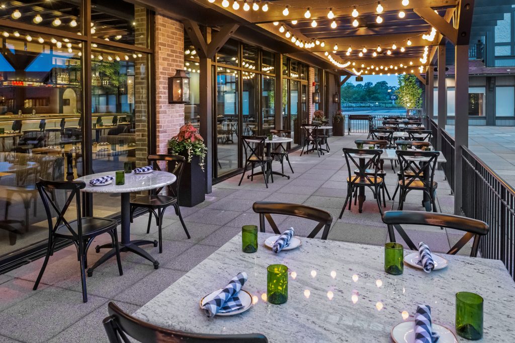 Basso on the Plaza outdoor patio with lights and tables and chairs